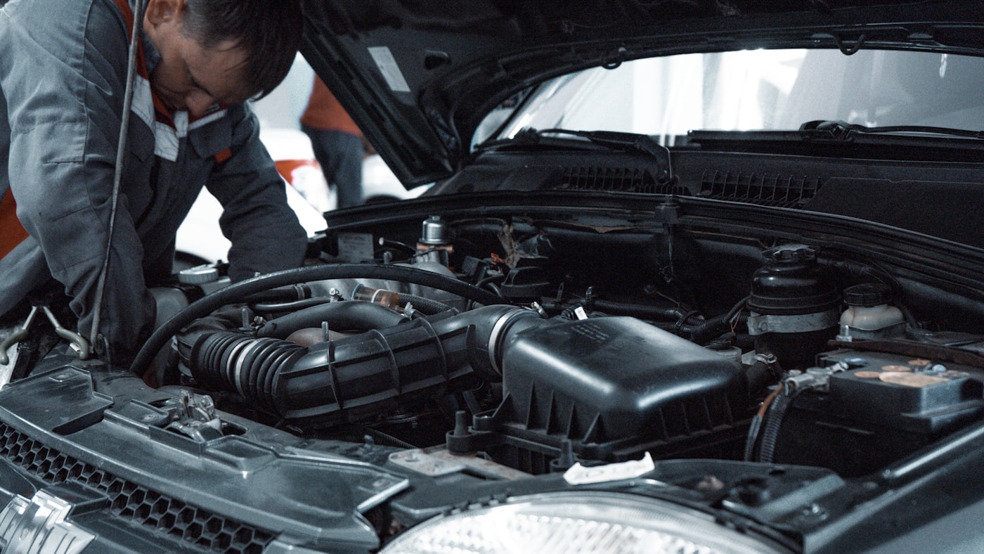 Technician working on a vehicle in a professional workshop